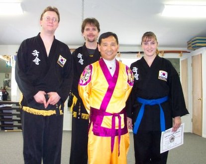 Ken Schalk (on the left) with two of his students and Grandmaster In Hyuk Suh during the 2003 summer seminar tour